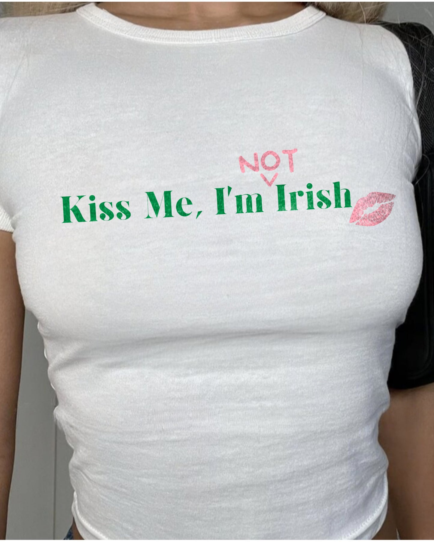 Model in White Kiss Me, I'm (Not) Irish Baby Tee in white. Featuring a cute kiss mark design.