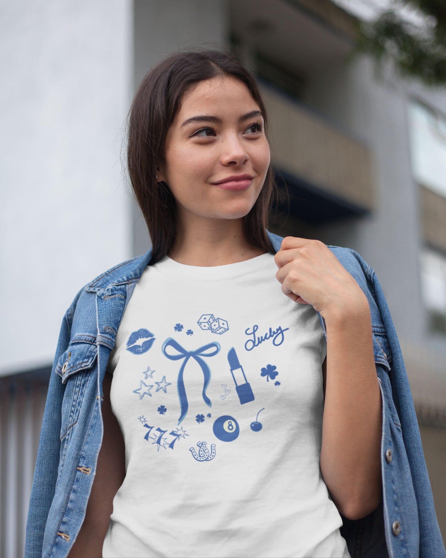 Cute Model wearing Lucky Icon Tee by Lucky Days. Shirt has a bow, lipsick, shamrocks, eight ball, 777, stars, dice, and luck.