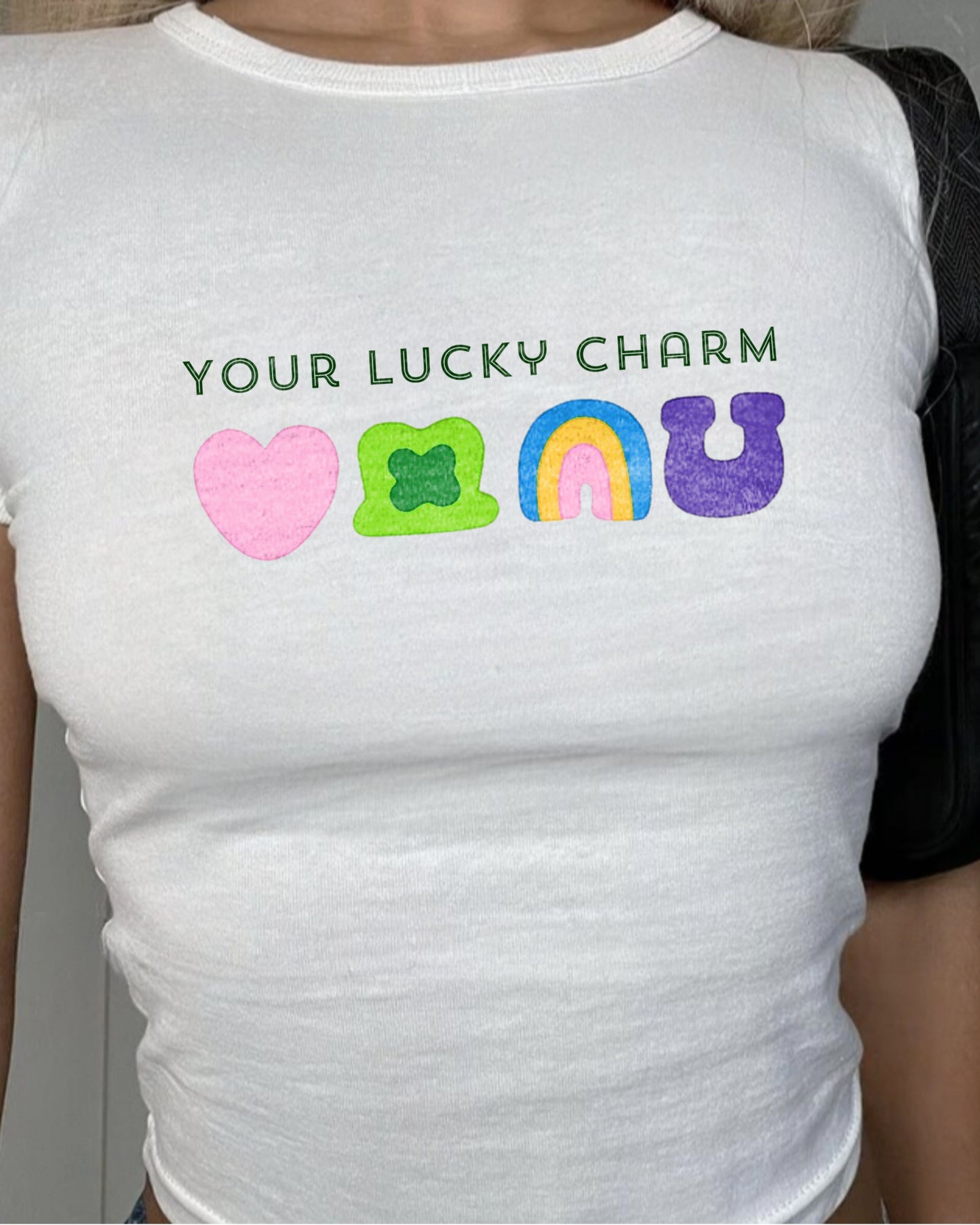 Your Lucky Charm white baby tee featuring lucky charm styling symbols