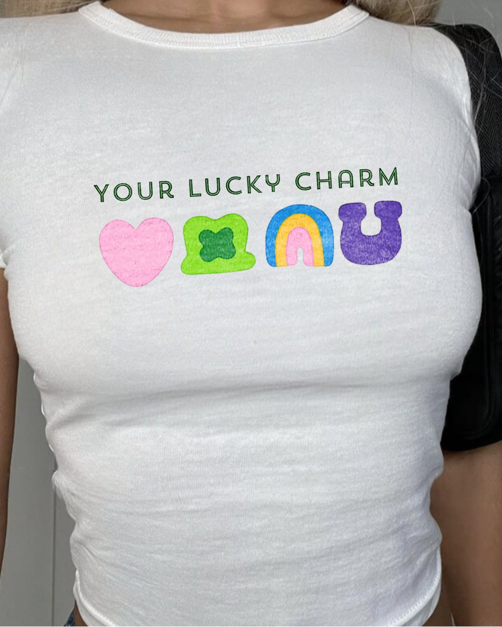 Your Lucky Charm white baby tee featuring lucky charm styling symbols